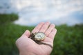 Hand holding retro stopwatch in natural background Royalty Free Stock Photo