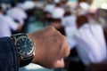 The watch in hand of teacher with control student doing educational exam test in classroom Royalty Free Stock Photo