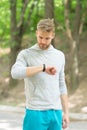 Watch ideal for active lifestyle. Athletic man check pulse by watch. Handsome athlete use smart watch during workout