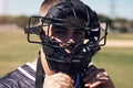 Watch me make baseball history. Portrait of a young man wearing a catchers helmet while playing a game of baseball. Royalty Free Stock Photo