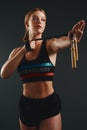 Watch me skip right over any obstacle. Studio shot of a sporty young woman posing with a skipping rope against a black