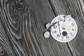 Watch mechanism details. Gears, arrows and dial. On brushed pine boards