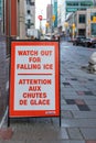 Watch out of falling snow and ice sign on the sidewalk warning of the danger Royalty Free Stock Photo