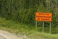 Watch for pedestrians on roadway sign beside a road Royalty Free Stock Photo