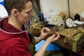 Watch restoration workshop of the state hermitage. Restorer at work repairs gears, watchmaker tools on the table