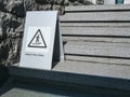 Watch your step Caution sign on stair step Building outdoor signage Royalty Free Stock Photo