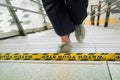 Watch your step sign sticker on the stairs at public area with a person walking up the stairs Royalty Free Stock Photo