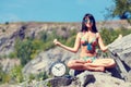 Watches and blurred girl sitting in the lotus position Royalty Free Stock Photo