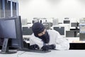 Watchful robber hacking computer in office Royalty Free Stock Photo