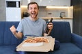 Watching the football game eating pizza,drinking beer. Royalty Free Stock Photo