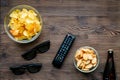 Watching movies set with chips on wooden background top view mock up