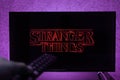 Watching Stranger Things television show on TV. Stranger Things is an American science fiction horror drama television series