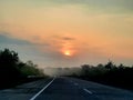 watching the sun rise from the foggy street Royalty Free Stock Photo