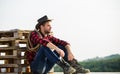 Watching sunset. Farmer cowboy handsome man relaxing after hard working day at ranch. Romanticism of western culture Royalty Free Stock Photo