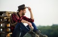 Watching sunset. Farmer cowboy handsome man relaxing after hard working day at ranch. Romanticism western culture