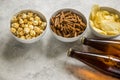 watching TV with beer, chips, pop corn and crumbs on stone background