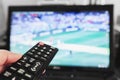 Watching tv, football match, movie and etc. Hand using remote control Royalty Free Stock Photo