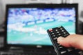 Watching tv, football match, movie and etc. Hand using remote control Royalty Free Stock Photo