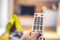 Watching TV in the living room. Relax. Technologies. Watching TV and using remote controller. Royalty Free Stock Photo