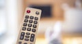 Watching TV in the living room. Relax. Technologies. Watching TV and using remote controller. Royalty Free Stock Photo