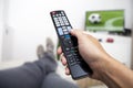 Watching TV. Remote control in hand. Football Royalty Free Stock Photo