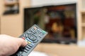 Watching TV and using black modern remote controller Royalty Free Stock Photo