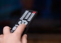 Watching TV and using remote controller Royalty Free Stock Photo