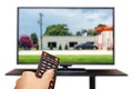 Watching TV and using remote controller Royalty Free Stock Photo