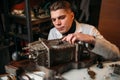 Watchmaker adjusts the mechanism of old wall clock Royalty Free Stock Photo