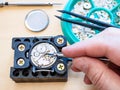 Watchmaker fixes clockwork of watch by screwdriver