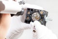 Watchmaker in head-mounted lenses adjusts watch