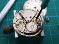 Watchmaker repairing old mechanical watch