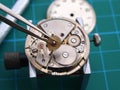 Watchmaker repairing old mechanical watch