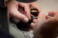 Watchmaker screwing a on a balancewheel