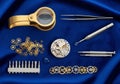 Watchmaking tools and components on a blue fabric background Royalty Free Stock Photo