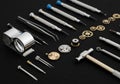 Watchmaking tools and components laid out on a black surface. Includes precision screwdrivers, Royalty Free Stock Photo