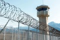 watchtower with barbed wire fence, security theme. Royalty Free Stock Photo