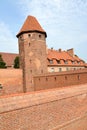 Watchtower and a fragment of the fortress wall of the chivalrous castle of the Teutonic Order. Marlbork, Poland Royalty Free Stock Photo