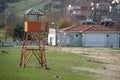 Watchtower for lifeguards on a meadow of green grass next to the sand