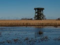 Watchtower at the meadow which are flooded by the water from close river