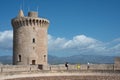 Watchtower of the old Bellver Castle with people walking near it, Palma, Mallorca island, Spain