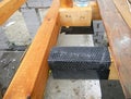 Wateproofing house roof wooden beams, trusses with bitumen material. House roofing construction