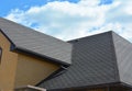 Wateproofing roof problem area with asphalt shingles and rain gutter. Asphalt shingles roofing construction