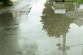 Water accumulate in the puddle on the asphalt road in the hole after heavy rain. Royalty Free Stock Photo