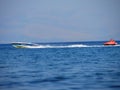 Water amusement on banana boat. summer holiday by the sea. Beautiful bright blue water and red and white boat and yellow banana bo