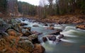 Water autumn landscape. A shallow fast mountain river with a rocky bottom.