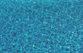 Water background. Blue water, ripples and highlights. Texture of water surface and tiled bottom.