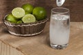 Water, baking soda and lemon; photo on wooden background