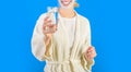 Water balance. Woman bathrobe hold glass of water. Morning habit to drink water. Health care concept. Stay hydrated