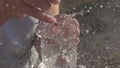 Water balloon exploding on wooden boards. Water explosion in slow motion